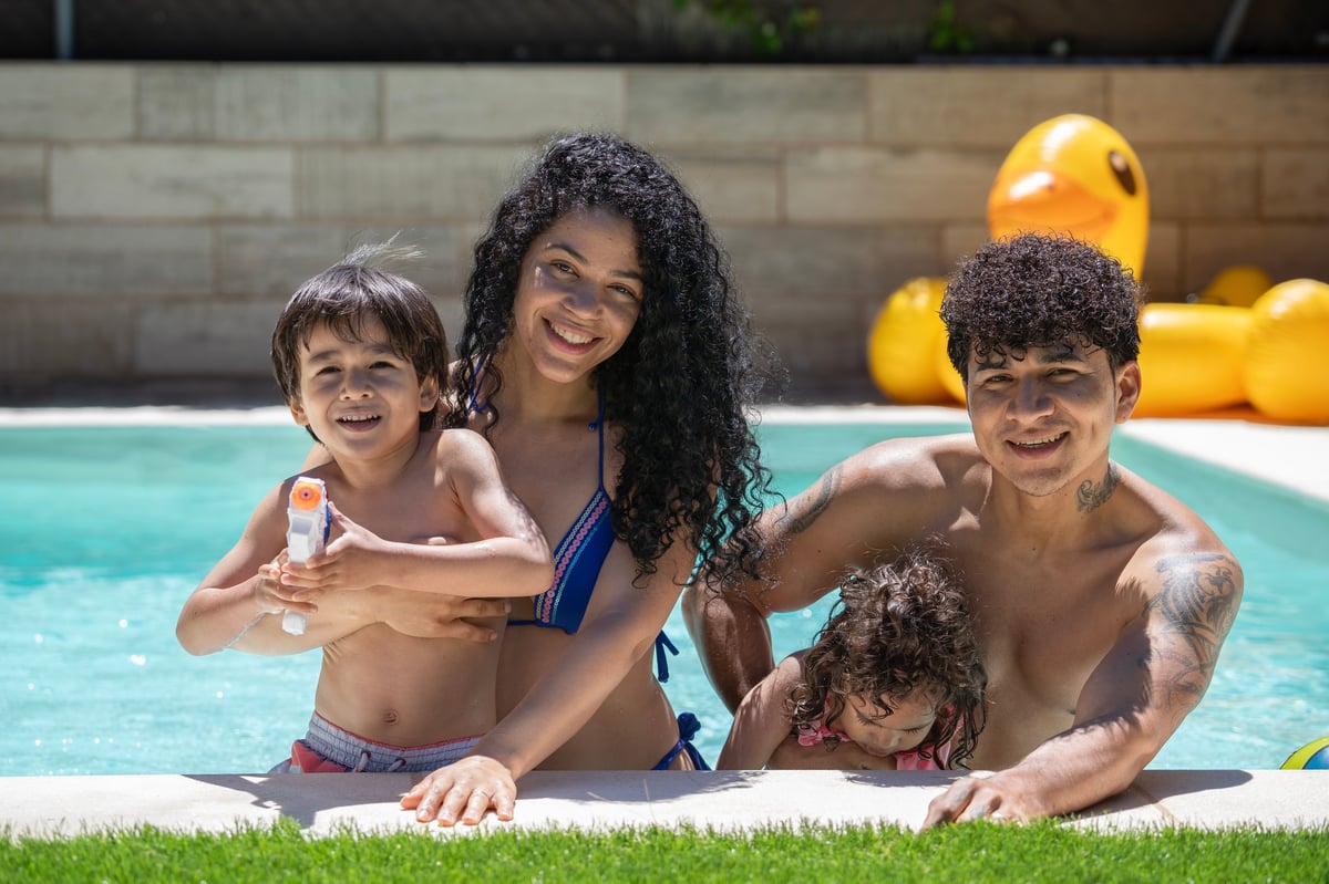 Happy family enjoying a day at the pool