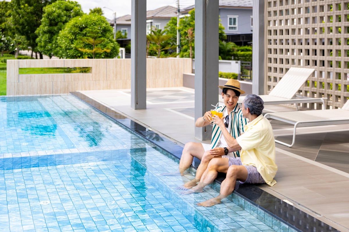 Father and son enjoying pool at hotel resort