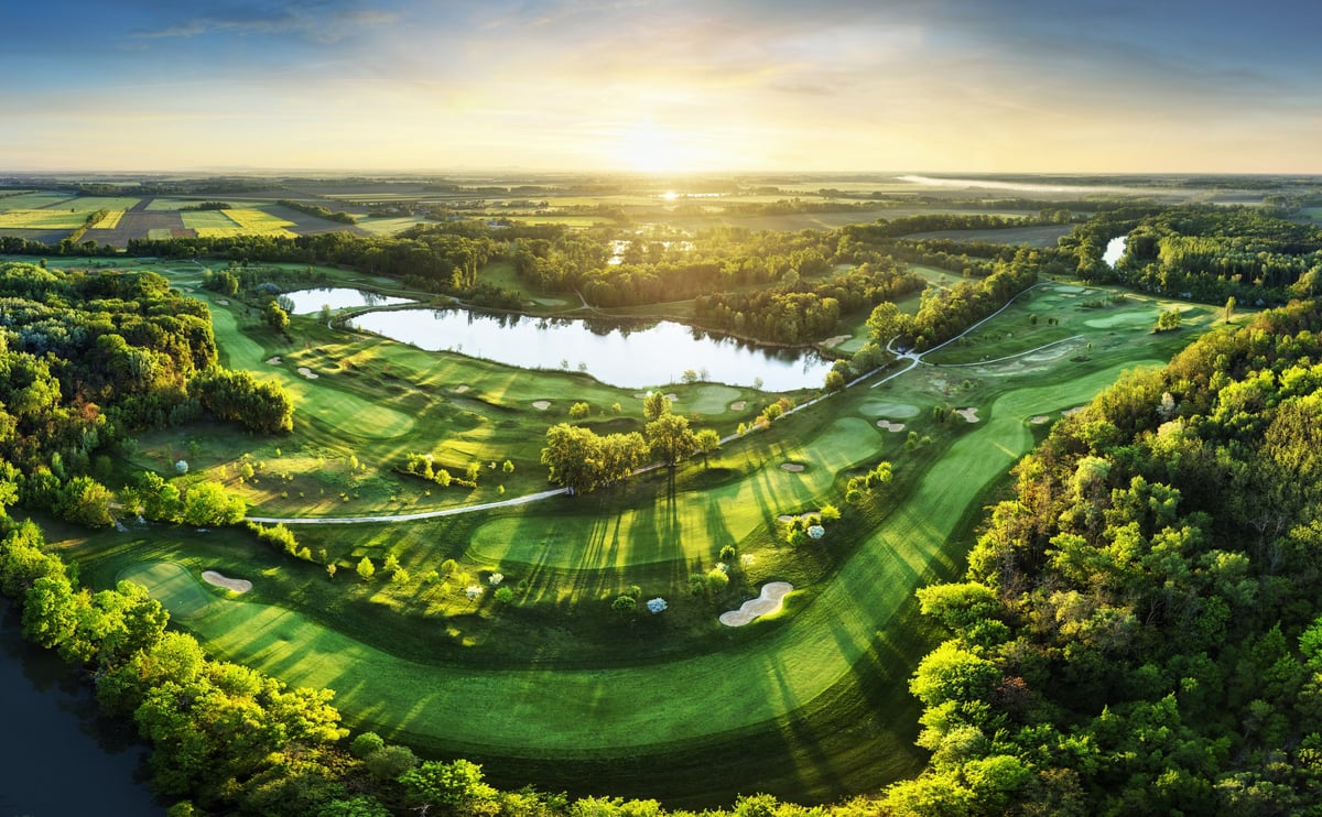 Golf course at sunset with beautiful sky and sand trap