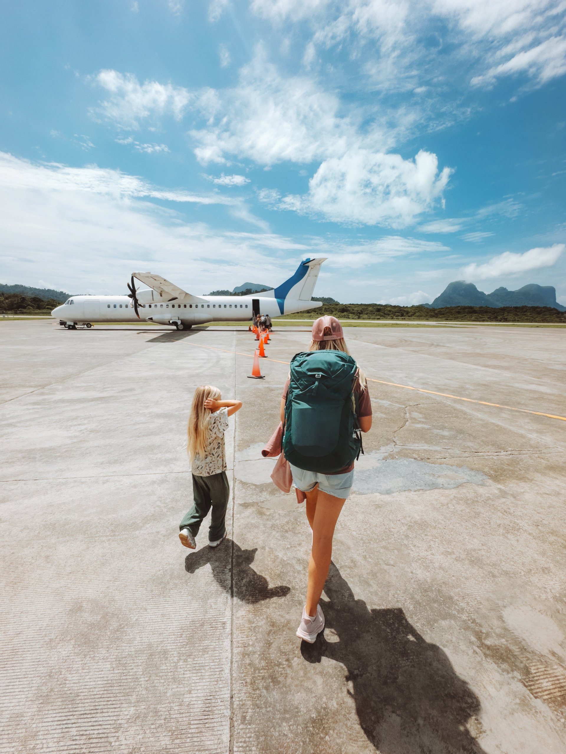 A mother and child at the airport boarding a plane, preparing to relocate as a family to Dubai