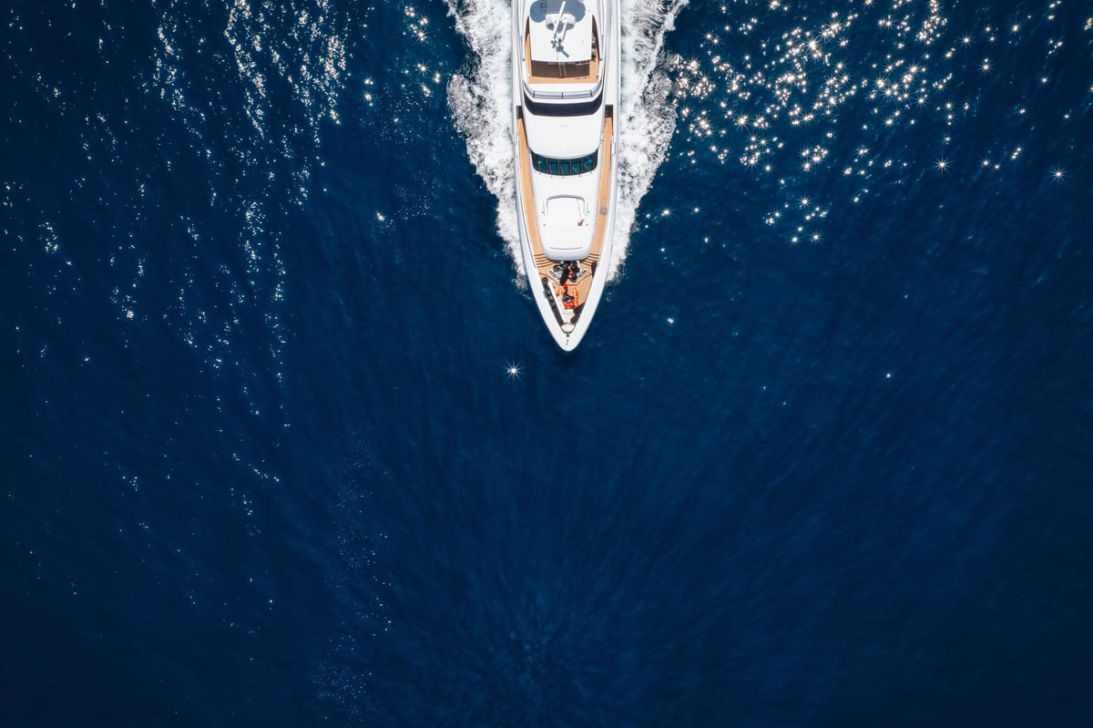 Aerial overhead view of a bow of a luxury yacht cruising