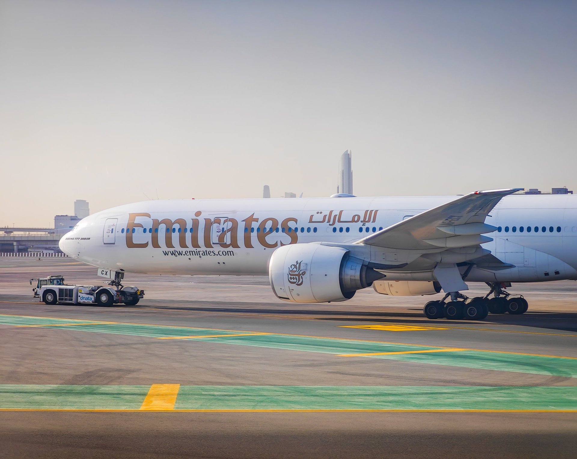 Emirates aircraft taxiing at Dubai International Airport, representing arriving expats opening UAE bank accounts