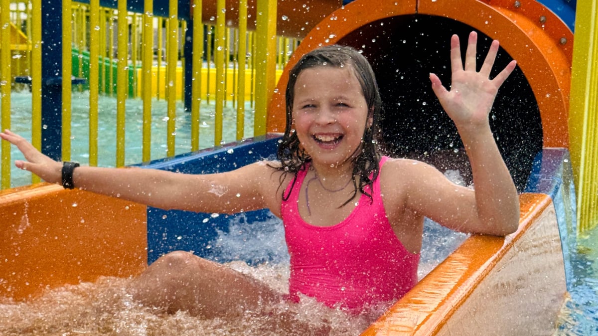 Happy children playing at aquapark water playground