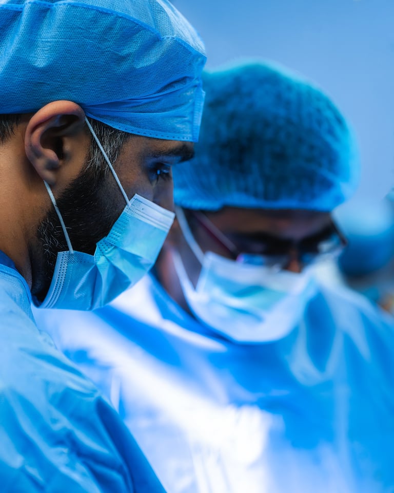 Healthcare workers in blue surgical suits, masks, and head coverings against a blue background