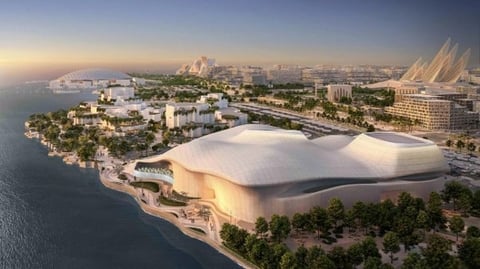 Futuristic white architectural building with curved design on waterfront peninsula surrounded by greenery and cityscape