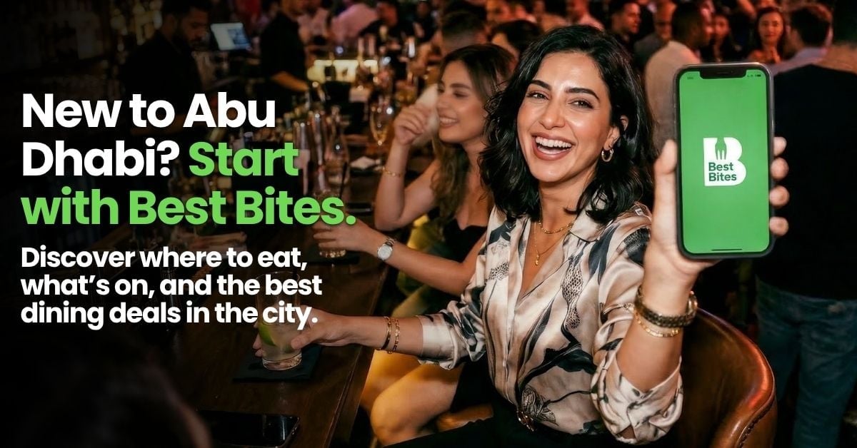 Woman at crowded restaurant holding phone displaying Best Bites app with text about dining deals in Abu Dhabi
