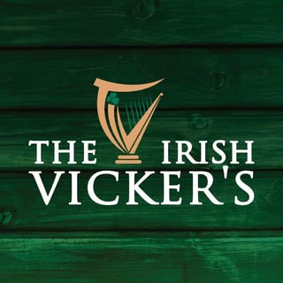 The Irish Vickers logo with gold harp symbol on green wooden background