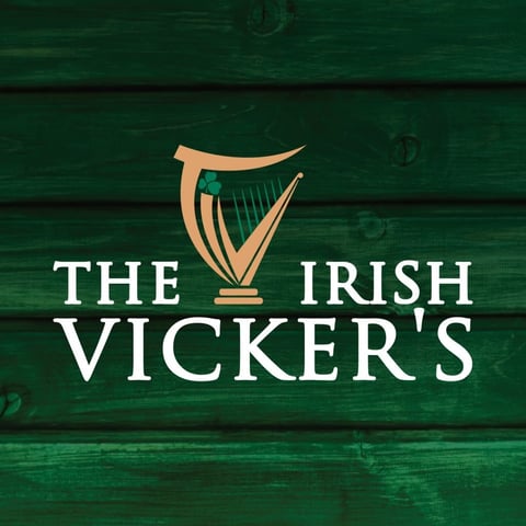 The Irish Vickers logo with gold harp symbol on green wooden background